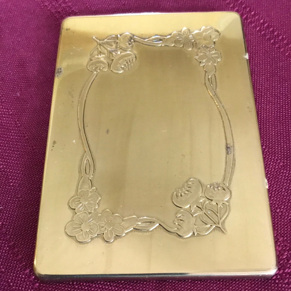 Handheld goldtone mirror with floral design